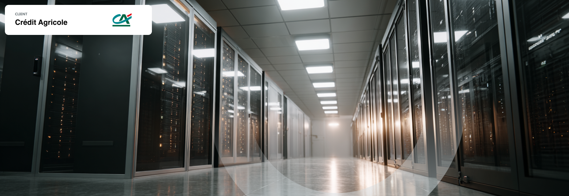 Empty data center hallway illuminated by white overhead lights.