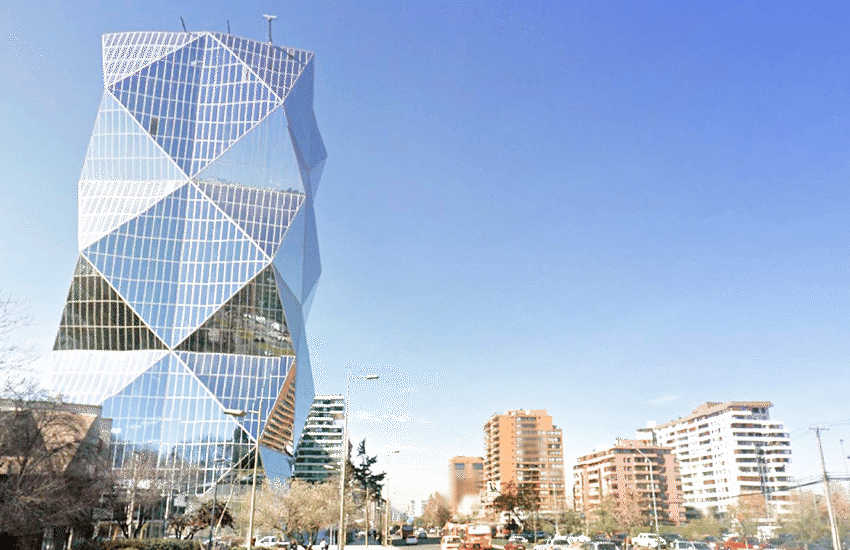 The ESIGN building in Santiago, Chile, a geometric glass office tower with a triangular faceted facade against the city skyline
