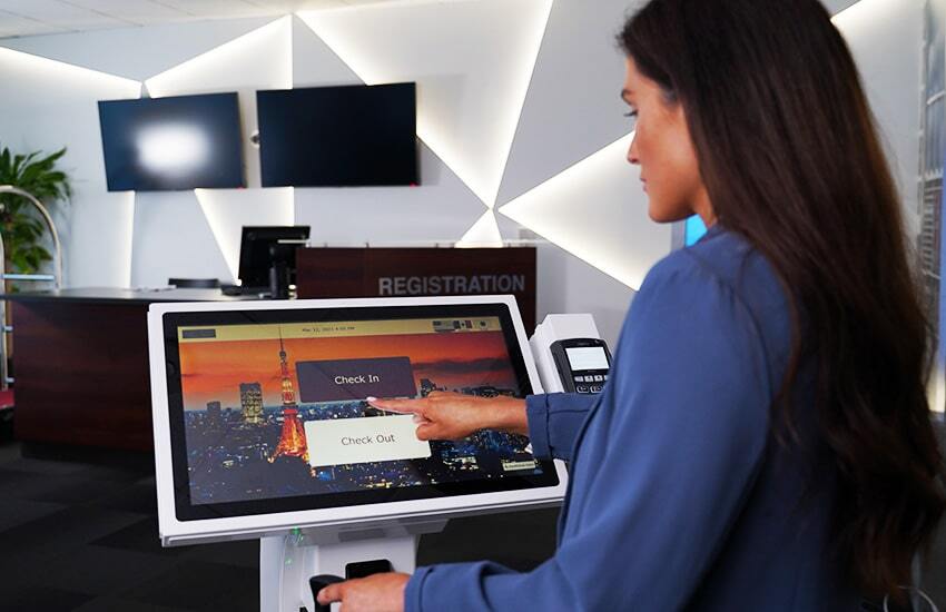 Lady interacting with a Smart Check-in solution on a tablet